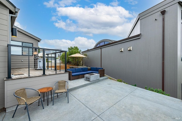 view of patio / terrace featuring an outdoor living space with a fire pit