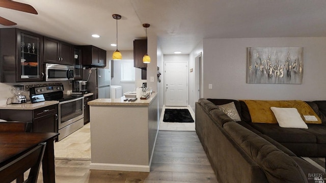 kitchen with stainless steel appliances, light hardwood / wood-style floors, dark brown cabinetry, ceiling fan, and pendant lighting