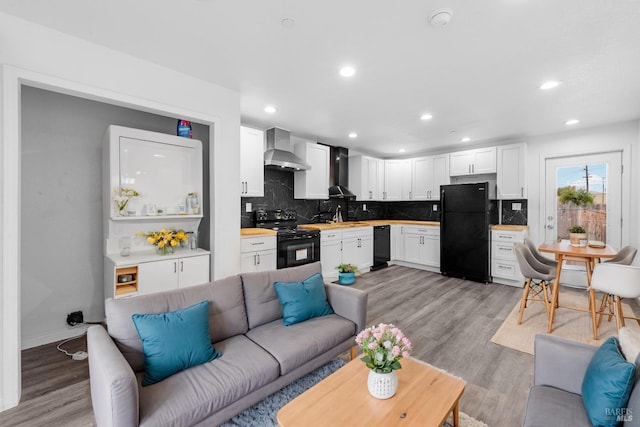 living room featuring light hardwood / wood-style flooring and sink