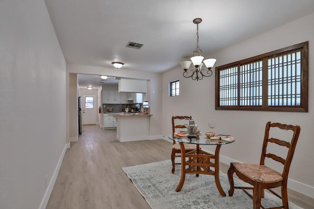 14090 Pine St, Walnut Grove, CA 95690 - dining room with a chandelier and light wood finished floors