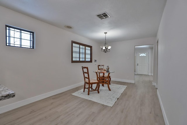 14090 Pine St, Walnut Grove, CA 95690 - dining room with light wood-type flooring and a chandelier