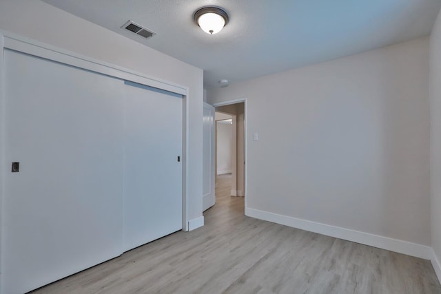 14090 Pine St, Walnut Grove, CA 95690 - unfurnished bedroom with light wood-style floors and a closet
