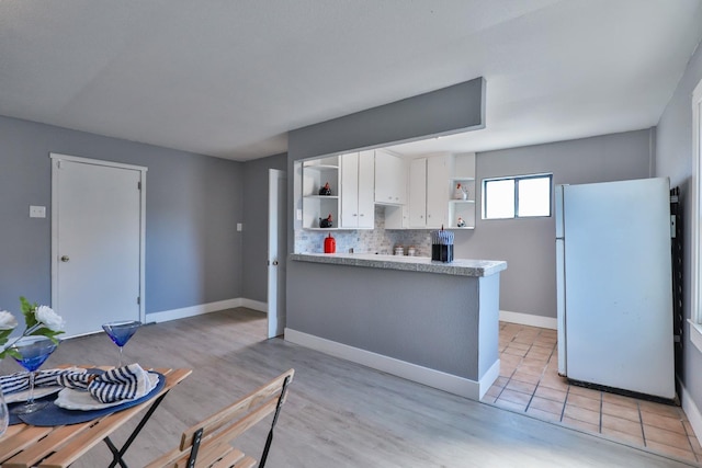 14090 Pine St, Walnut Grove, CA 95690 - kitchen featuring freestanding refrigerator, open shelves, white cabinetry, light countertops, and decorative backsplash
