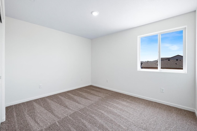 spare room with carpet flooring and baseboards