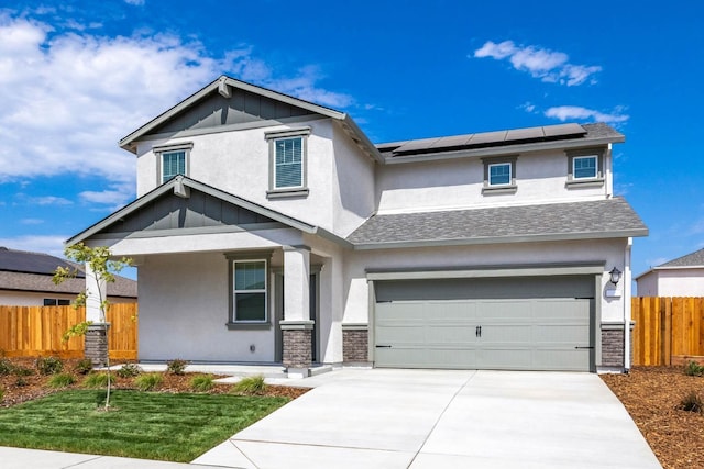 view of front of home featuring concrete driveway, stucco siding, fence, and roof mounted solar panels