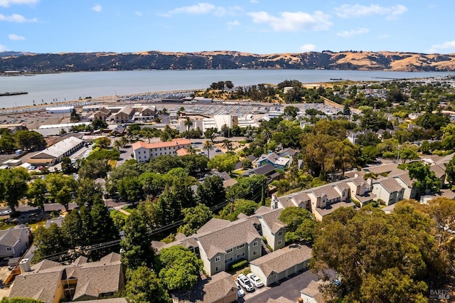 drone / aerial view featuring a water and mountain view