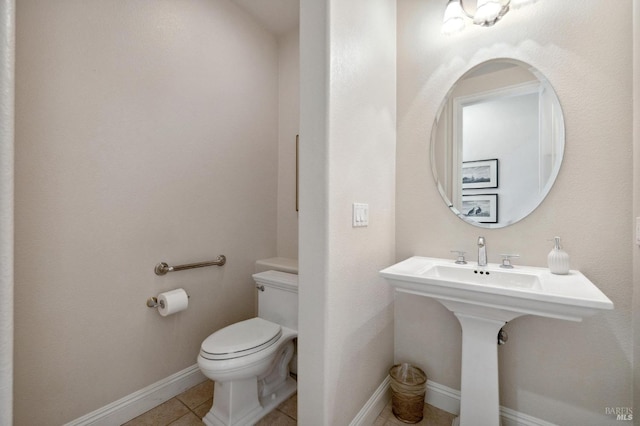 bathroom featuring toilet and tile patterned floors