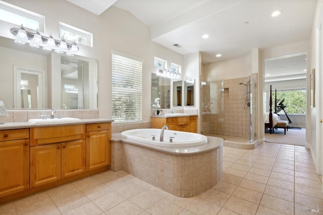 bathroom featuring vanity, tile patterned flooring, and plus walk in shower