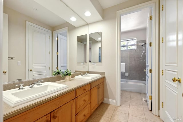 bathroom with tiled shower / bath combo, tile patterned floors, and vanity