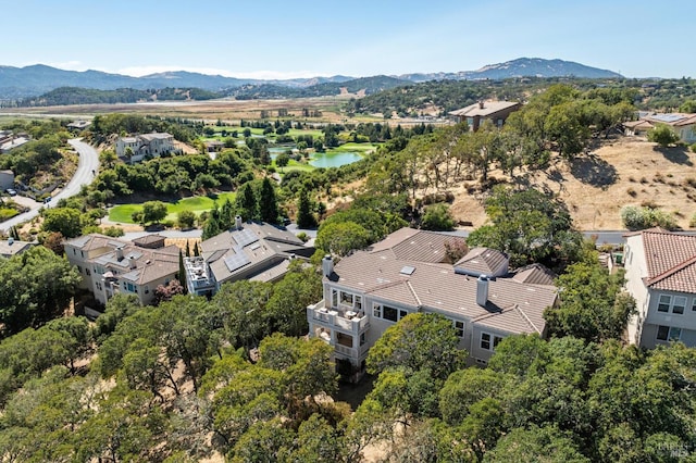 birds eye view of property with a water and mountain view