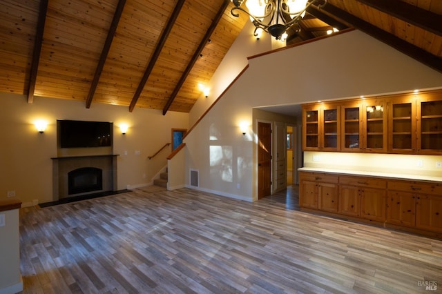 unfurnished living room with baseboards, light wood finished floors, and stairs