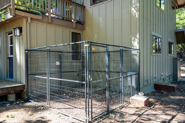 view of side of property with board and batten siding and a balcony