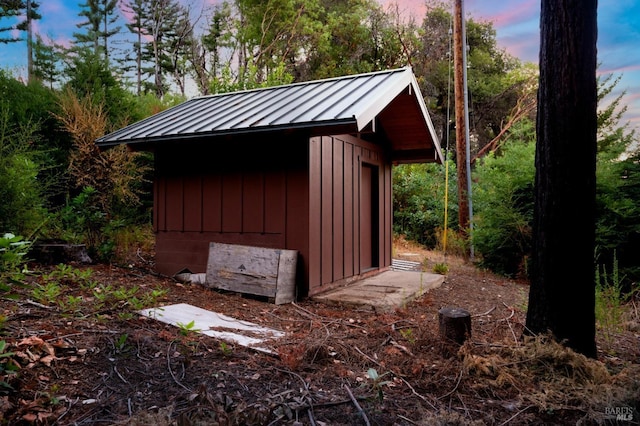 outdoor structure at dusk featuring a storage shed and an outdoor structure