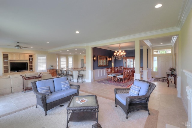 tiled living room with built in shelves, crown molding, and ceiling fan with notable chandelier