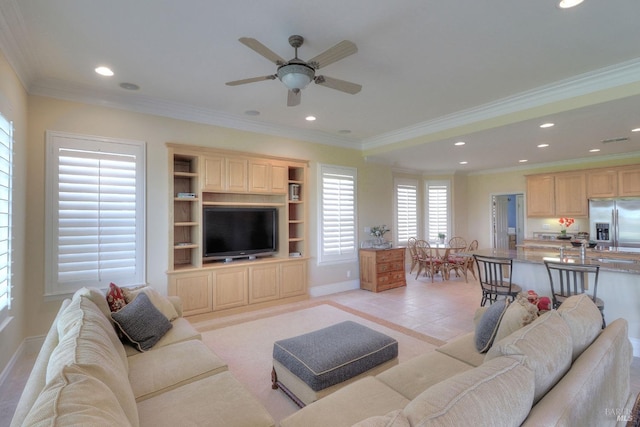 tiled living room with ornamental molding and ceiling fan