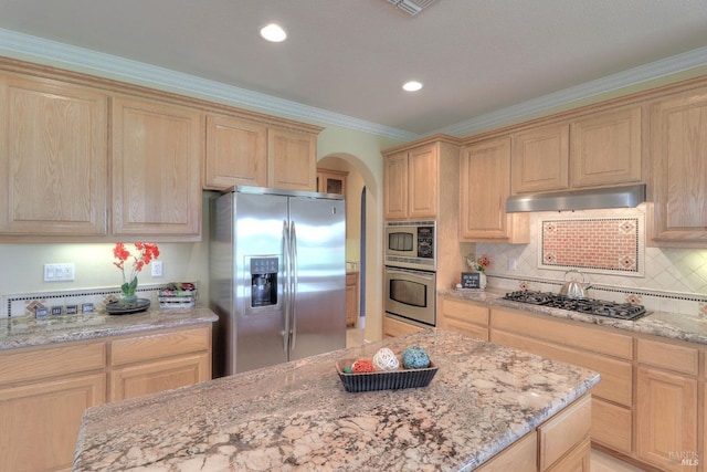 kitchen with light brown cabinetry, light stone counters, ornamental molding, appliances with stainless steel finishes, and decorative backsplash