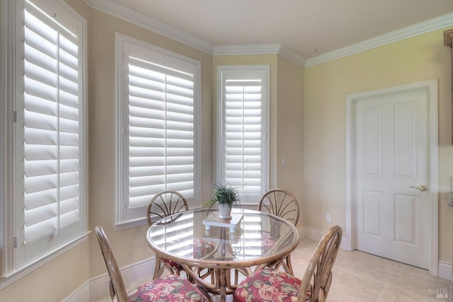 tiled dining room featuring crown molding