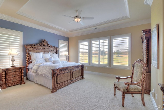 bedroom featuring crown molding, carpet floors, a raised ceiling, and ceiling fan