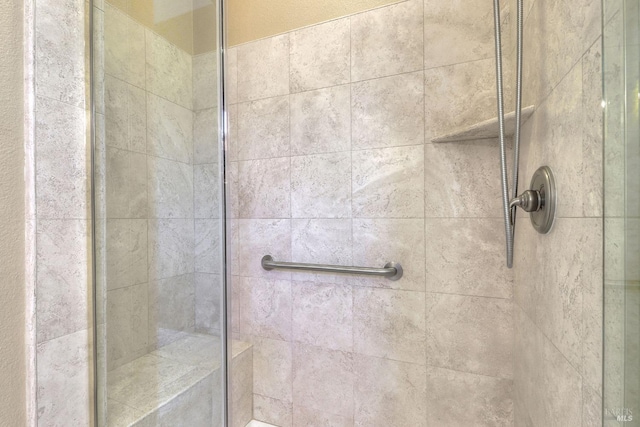 bathroom with a tile shower