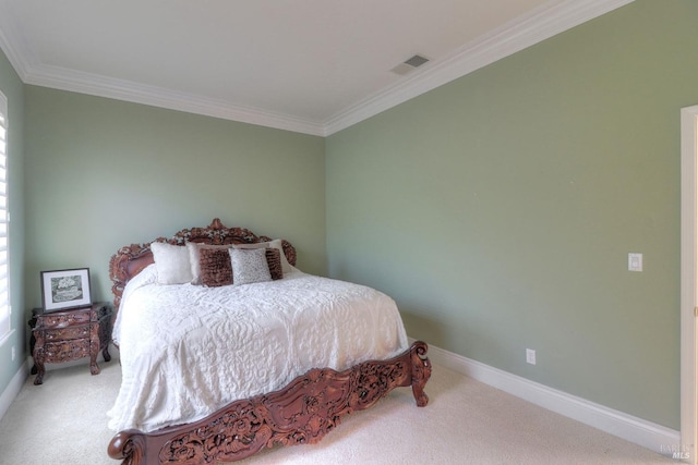 bedroom with ornamental molding and carpet flooring