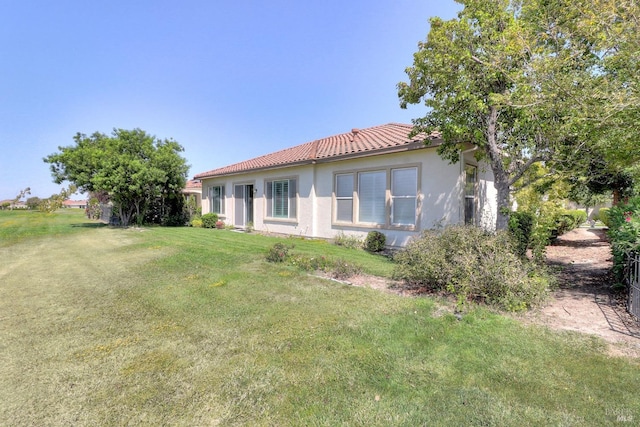 rear view of property featuring a yard