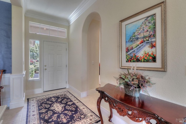 tiled foyer featuring crown molding