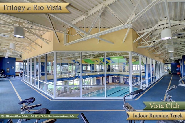 workout area featuring a towering ceiling