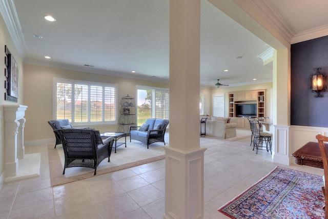 tiled living room with ceiling fan, crown molding, a fireplace, and built in shelves