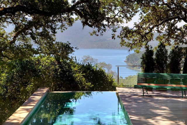 view of pool featuring a water view