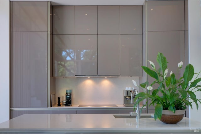 kitchen featuring cooktop, light countertops, modern cabinets, and gray cabinets