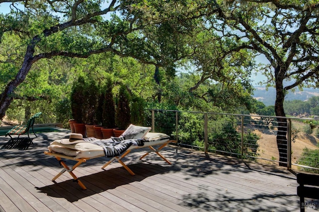 wooden deck with a view of trees