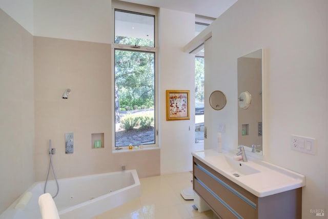 full bath with vanity and a tub