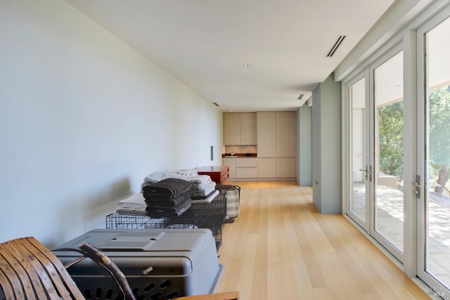 living room featuring visible vents and light wood-style flooring