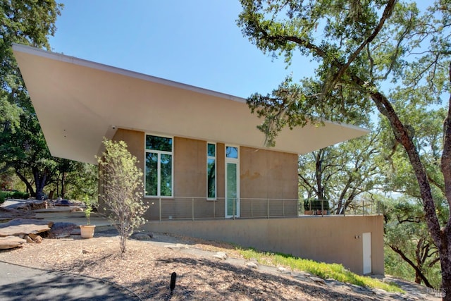 rear view of house with stucco siding