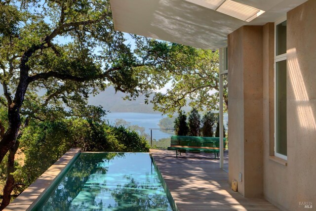 view of swimming pool with a water view