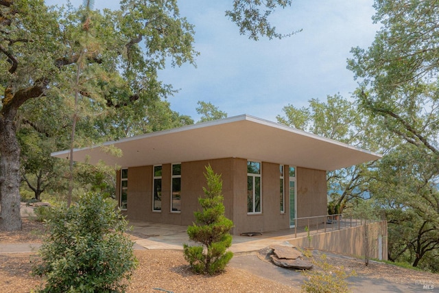 view of front of home with a patio and stucco siding