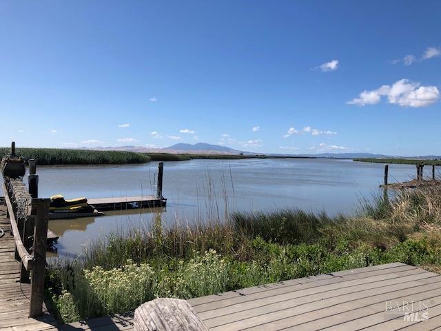 view of dock featuring a water and mountain view