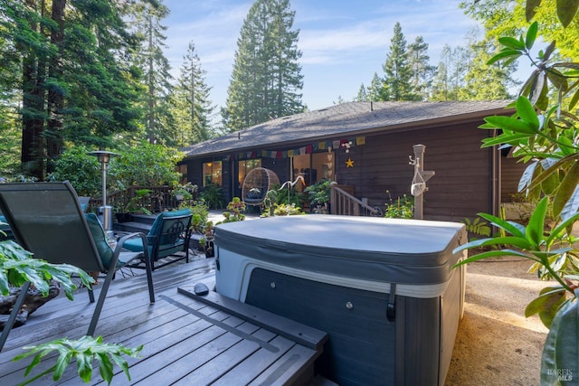 wooden deck featuring a hot tub