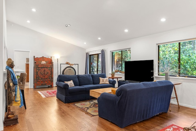 living room with lofted ceiling, baseboards, light wood-style flooring, and recessed lighting