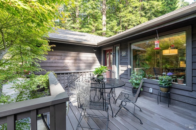 wooden deck featuring outdoor dining space