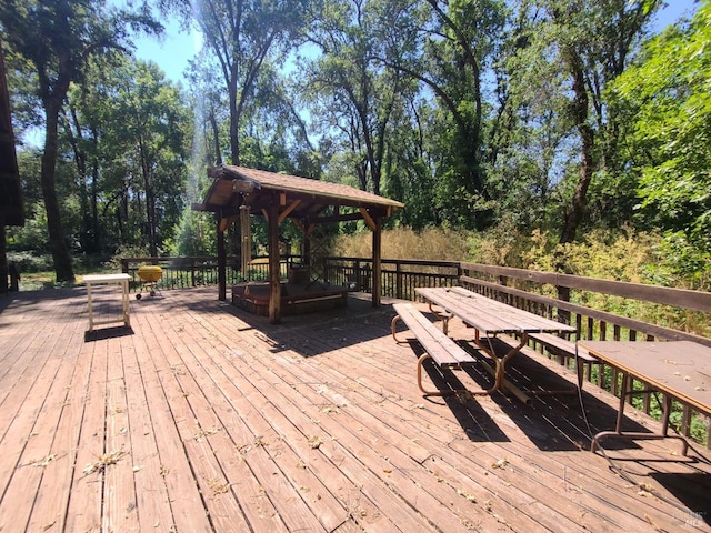 wooden terrace featuring a gazebo