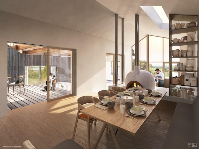 dining area with light hardwood / wood-style flooring and a high ceiling