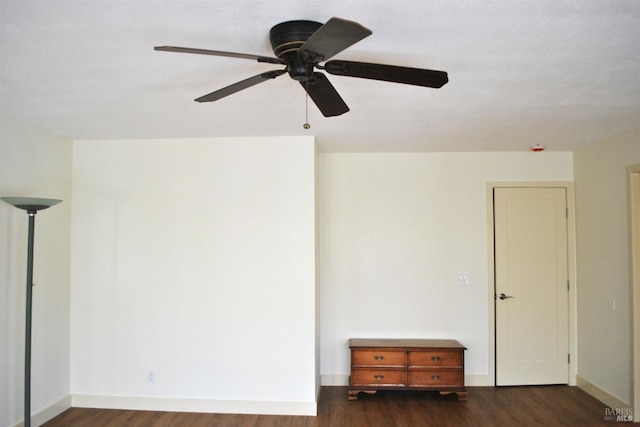 empty room featuring ceiling fan and dark hardwood / wood-style flooring