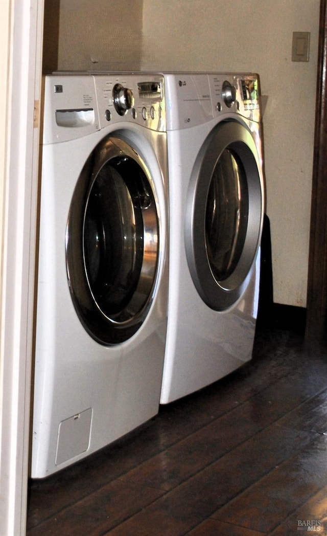 clothes washing area featuring separate washer and dryer and dark hardwood / wood-style floors