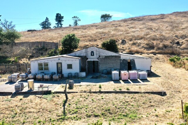 view of front of home featuring a patio area and fence