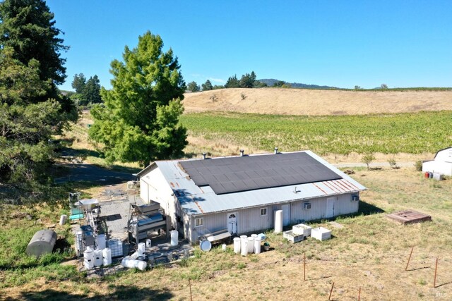 birds eye view of property with a rural view