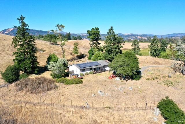 drone / aerial view featuring a rural view and a mountain view