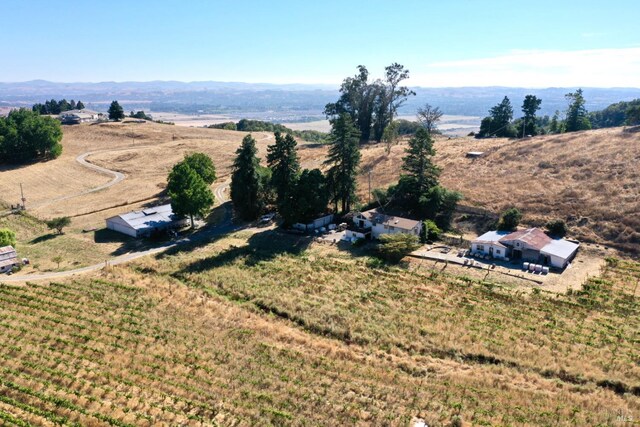 bird's eye view featuring a rural view and a mountain view