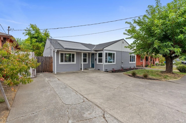 single story home featuring solar panels