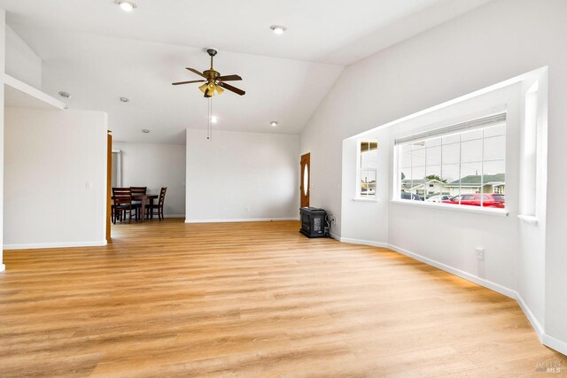 unfurnished living room featuring light hardwood / wood-style floors, ceiling fan, and vaulted ceiling